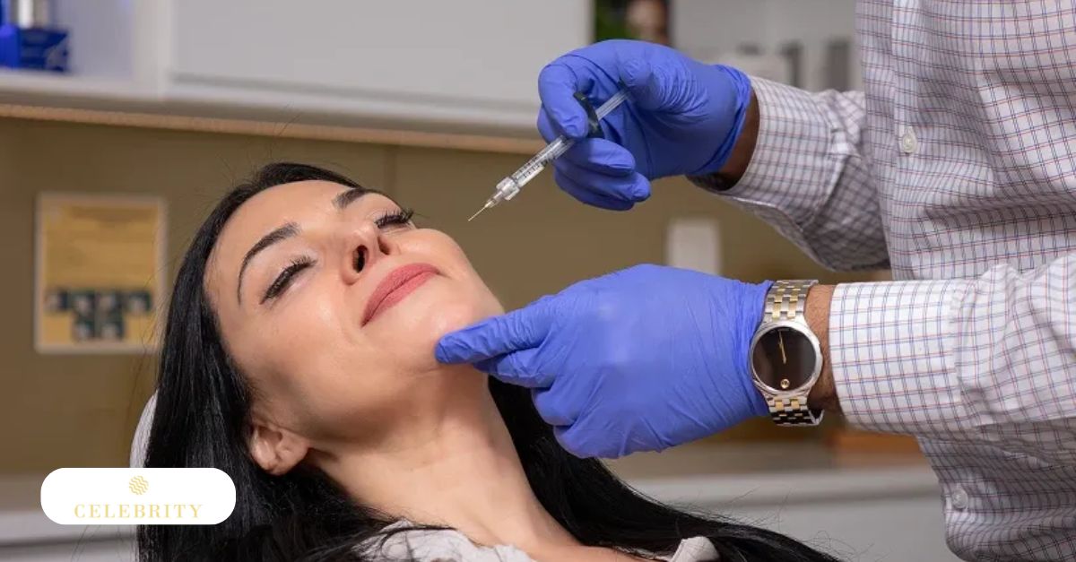Professional injects syringe into woman's cheek while steadying her chin during anti-aging dermal filler treatment.