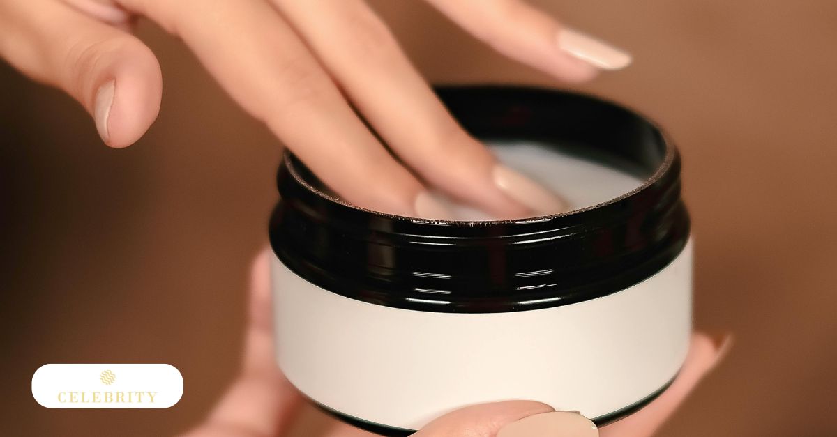 A close-up of fingers dipping into a jar of white cream, illustrating the application of depilatory creams for removing nipple hairs
