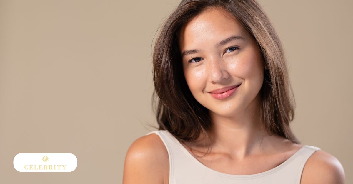 A woman with a joyful expression, hands on her face, highlighting the results of skin rejuvenation techniques
