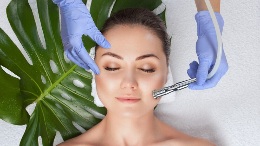 Cosmetologist makes microdermabrasion procedure facial skin