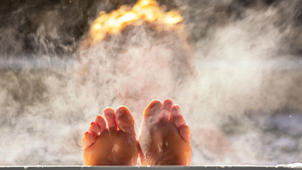 Woman holds her feet up in hot tub