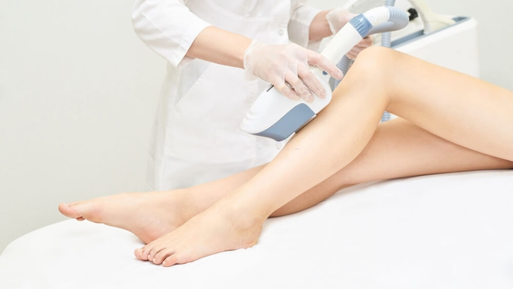 Laser ipl device in doctor's hand doing woman body hair removal