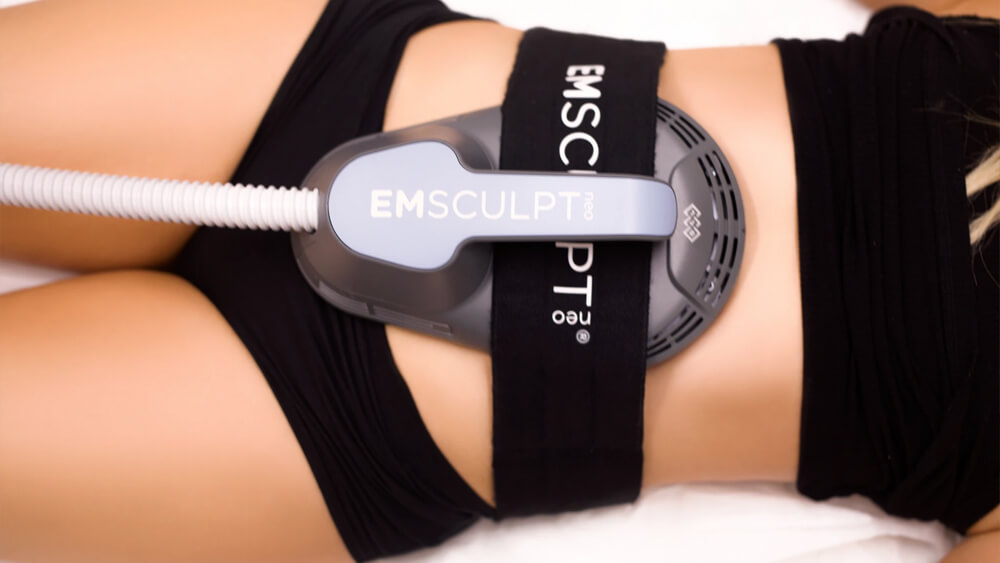 Belly of woman under Emsculpt Neo device