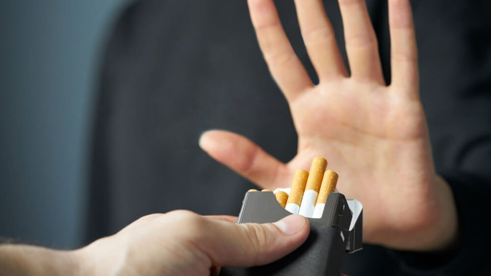 Stop smoking concept and hand is refusing cigarette offer