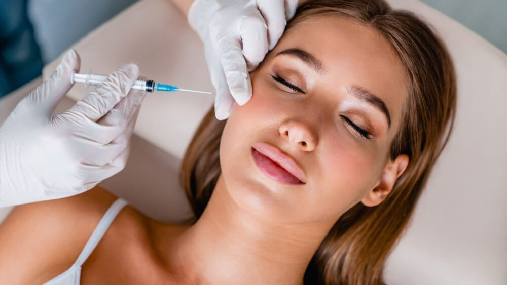 Young woman gets beauty facial Botox in salon