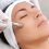 Cosmetologist does microneedling on facial skin