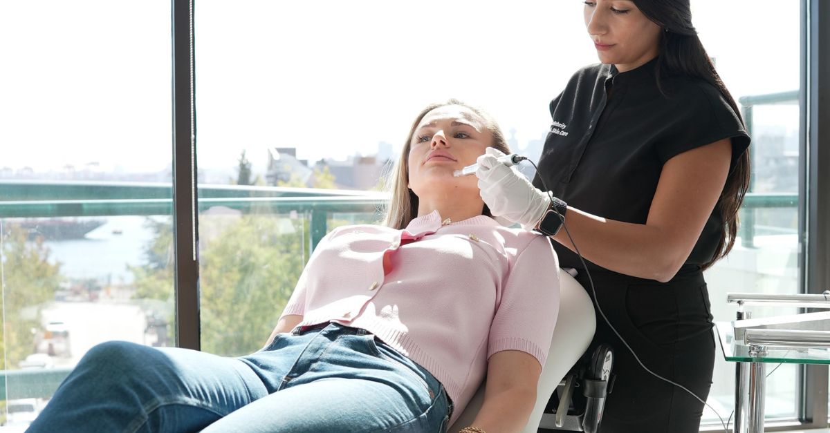 A technician performing a microneedling with PRP treatment on a client's chin for natural skin rejuvenation.