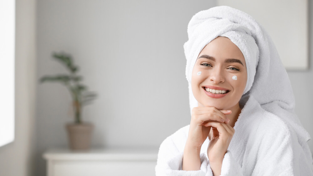 Smiling woman with skincare routine