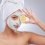 Woman wearing face mask and holding a lemon