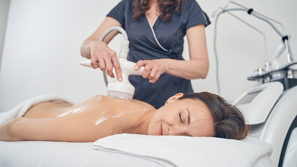 Woman feeling good getting body contouring treatment