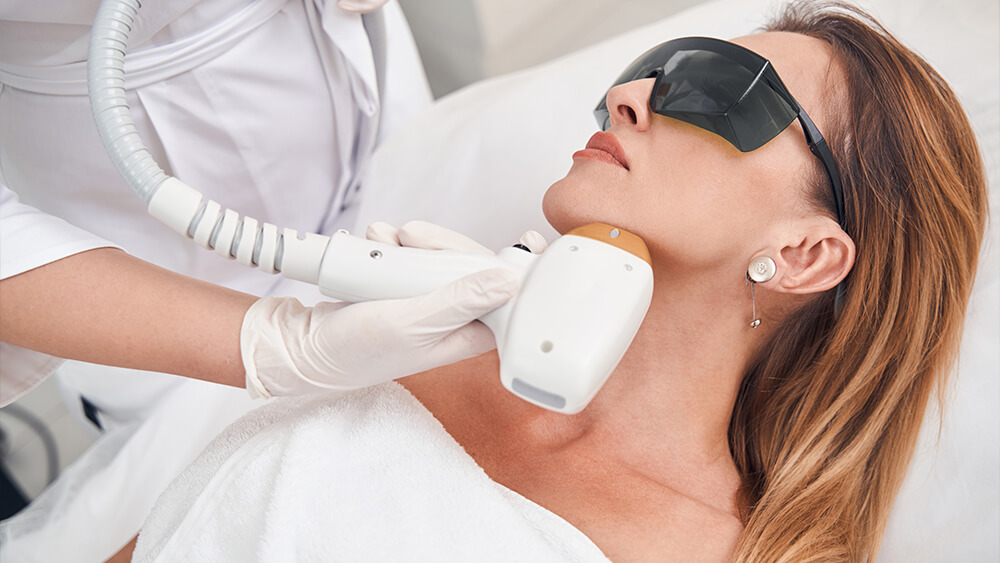 Calm female during laser treatment with professional IPL device