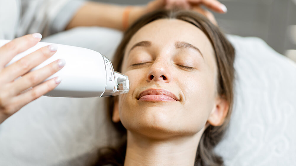 Rejuvenation procedure with IPL treatment on a woman's face