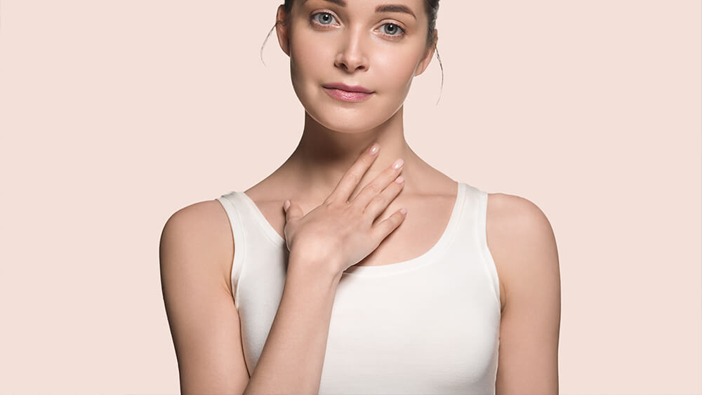 Beautiful skin healthy woman face touching her neck with hand