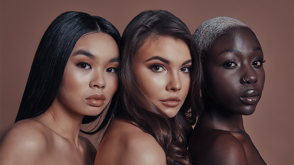 Closeup of three women with skin types and tones