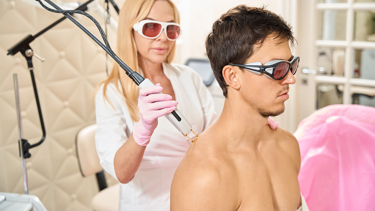 Male athlete under laser hair removal treatment on his back
