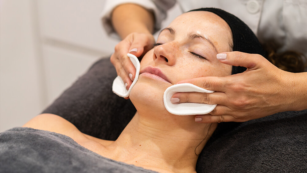 Relaxed woman having facial beauty treatment