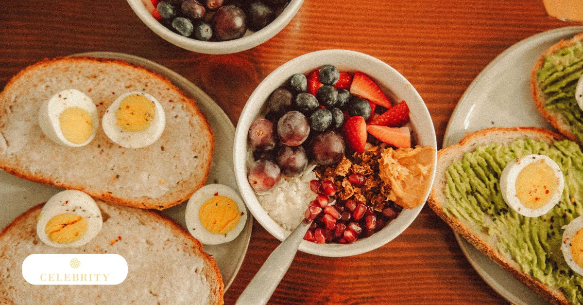 A top-down view of a wooden table features a nutritious breakfast spread, including avocado toast with boiled eggs and a yogurt bowl topped with fresh berries, highlighting how a healthy diet impact on hair growth begins with essential nutrients.