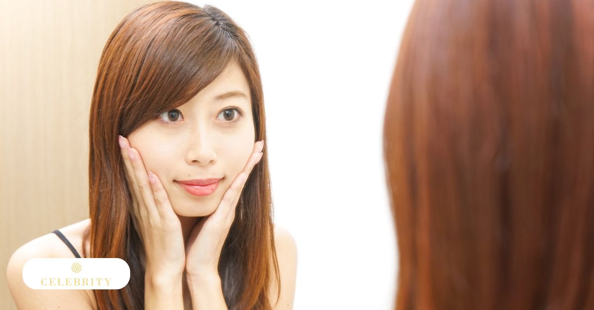 A woman examines her eyes in the mirror, focusing on her permanent eyeliner aftercare routine