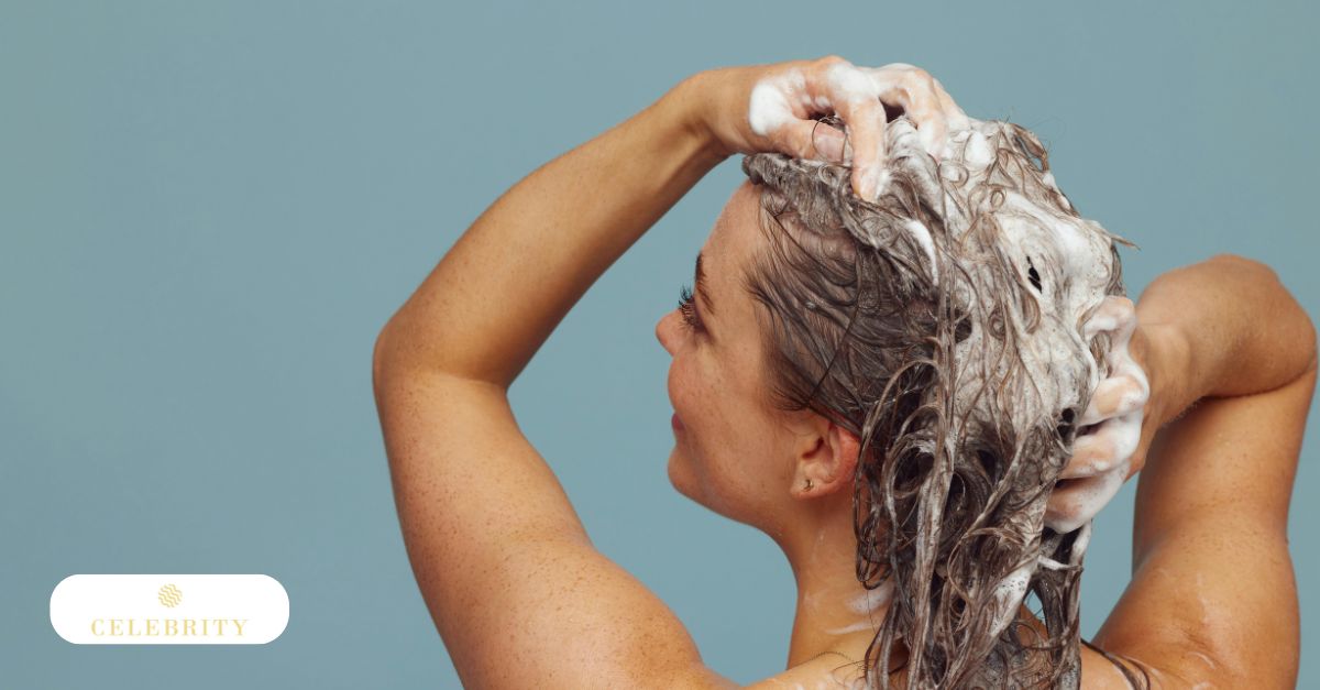 A woman massages a rich lather into her hair and scalp during her shower routine, demonstrating how to effectively apply ketoconazole shampoo for hair growth and scalp health.