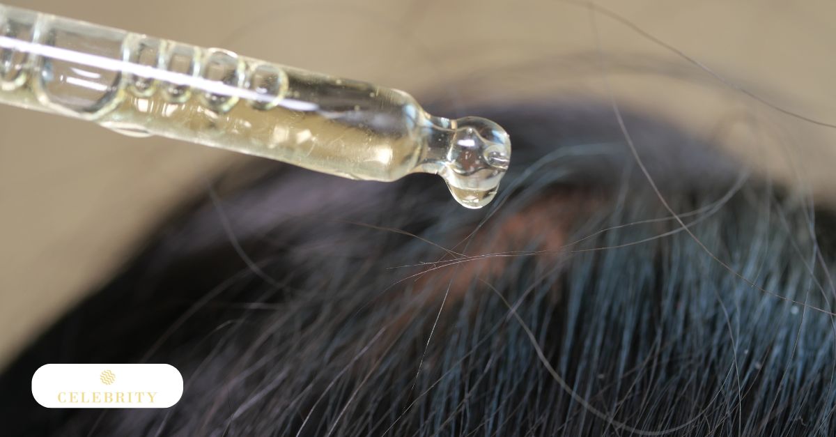 A glass dropper releases a nourishing drop of serum directly onto the scalp, illustrating the simple application of natural oils for hair growth and improved scalp health.