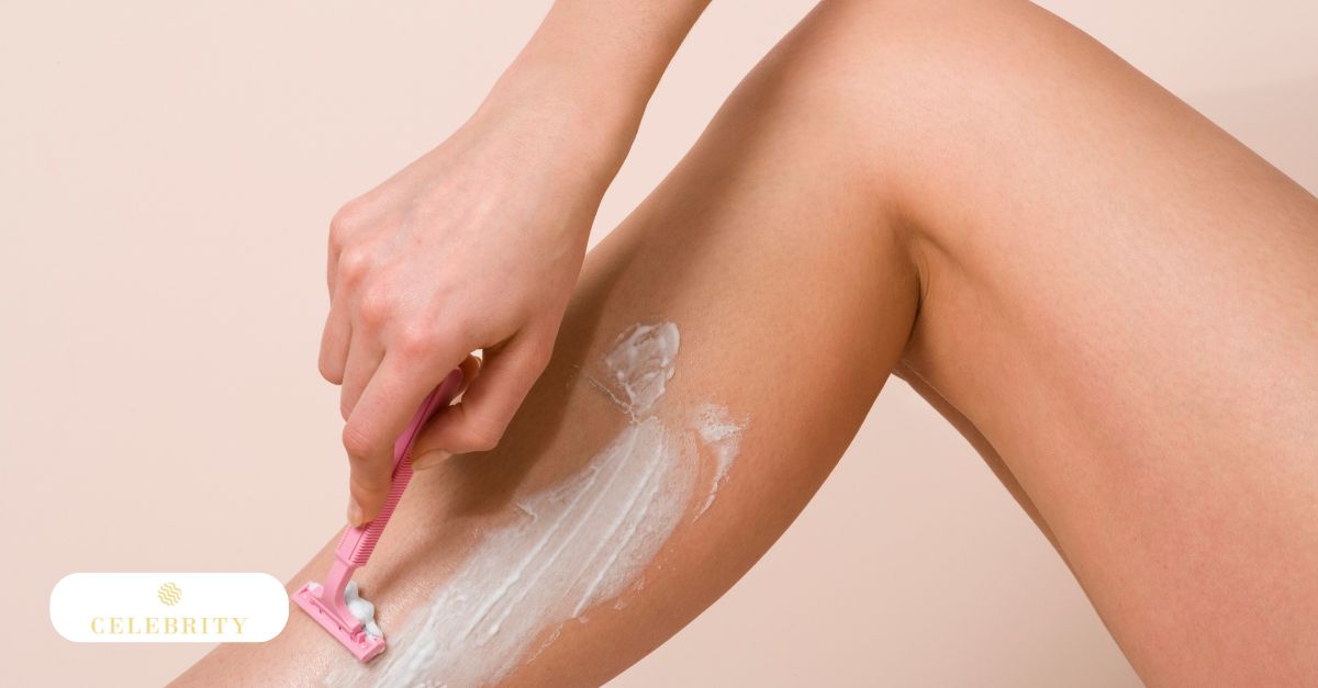 A woman carefully shaving her legs with a razor, highlighting an effective treatment for strawberry legs