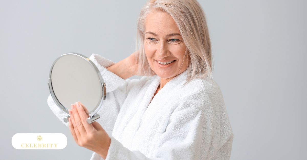 A woman smiles at her reflection in the mirror, showcasing her improved appearance after Morpheus8 treatment for under-eye bags