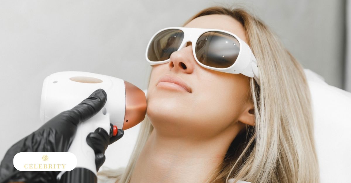 Close-up of a blonde woman wearing protective white goggles while receiving a facial laser treatment.