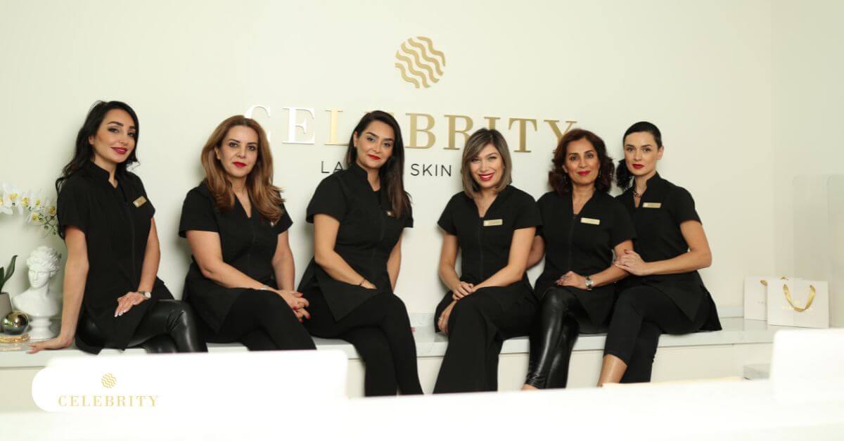 Team of skincare professionals at Celebrity Laser & Skin Care smiling and sitting together in front of clinic logo