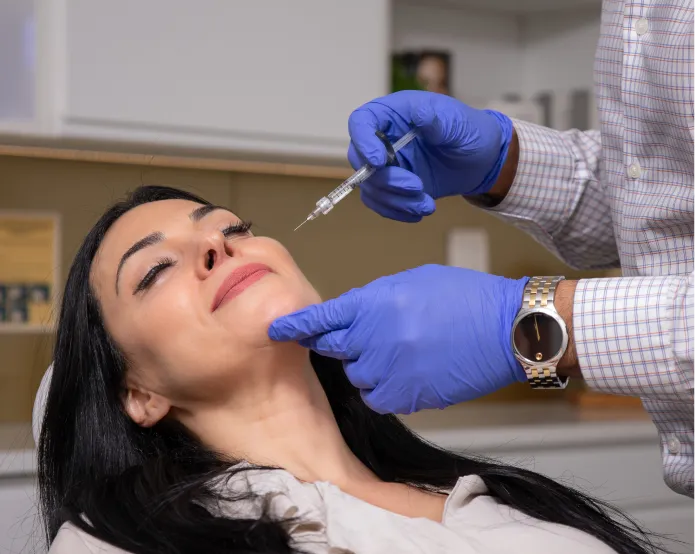 A clinician preparing Botox and Dysport injections during a cosmetic treatment