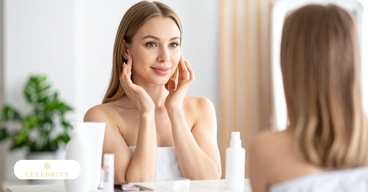 Woman gently touching her face while looking in the mirror, exploring the benefits of face yoga for aging skin and facial awareness.
